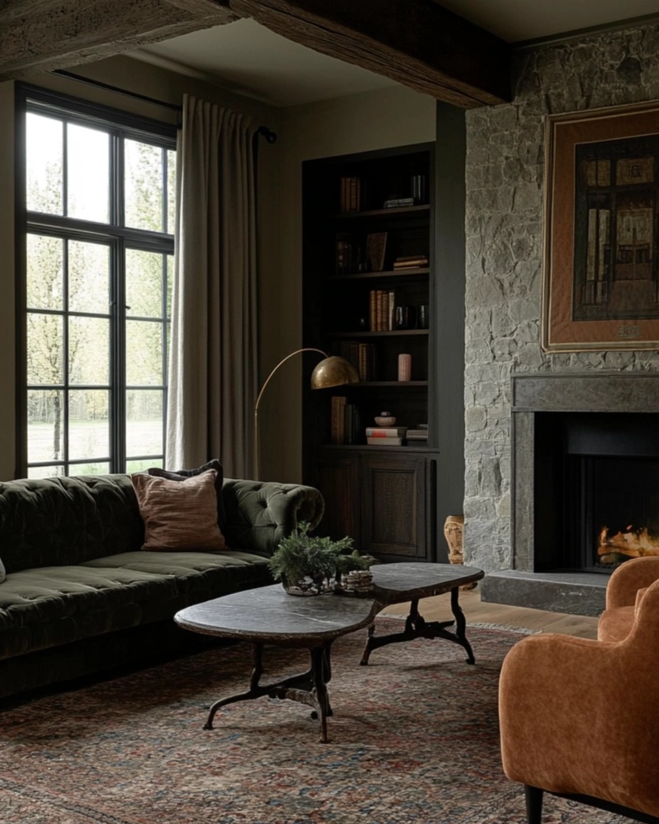 Cozy living room with a fireplace, bookshelf, and comfortable furniture.