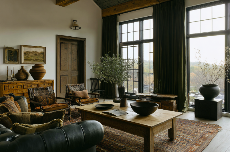 Vintage furniture display with reclaimed wood table, antique chairs, and warm layered textures – Hello Norden
