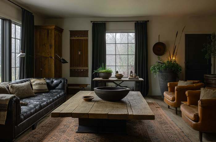 Living room with rustic home furniture including leather sofa, wood coffee table, and accent chairs styled for comfort and natural texture.
