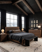 Kare Bed Hello Norden in a modern mountain bedroom with dark wood walls and beams